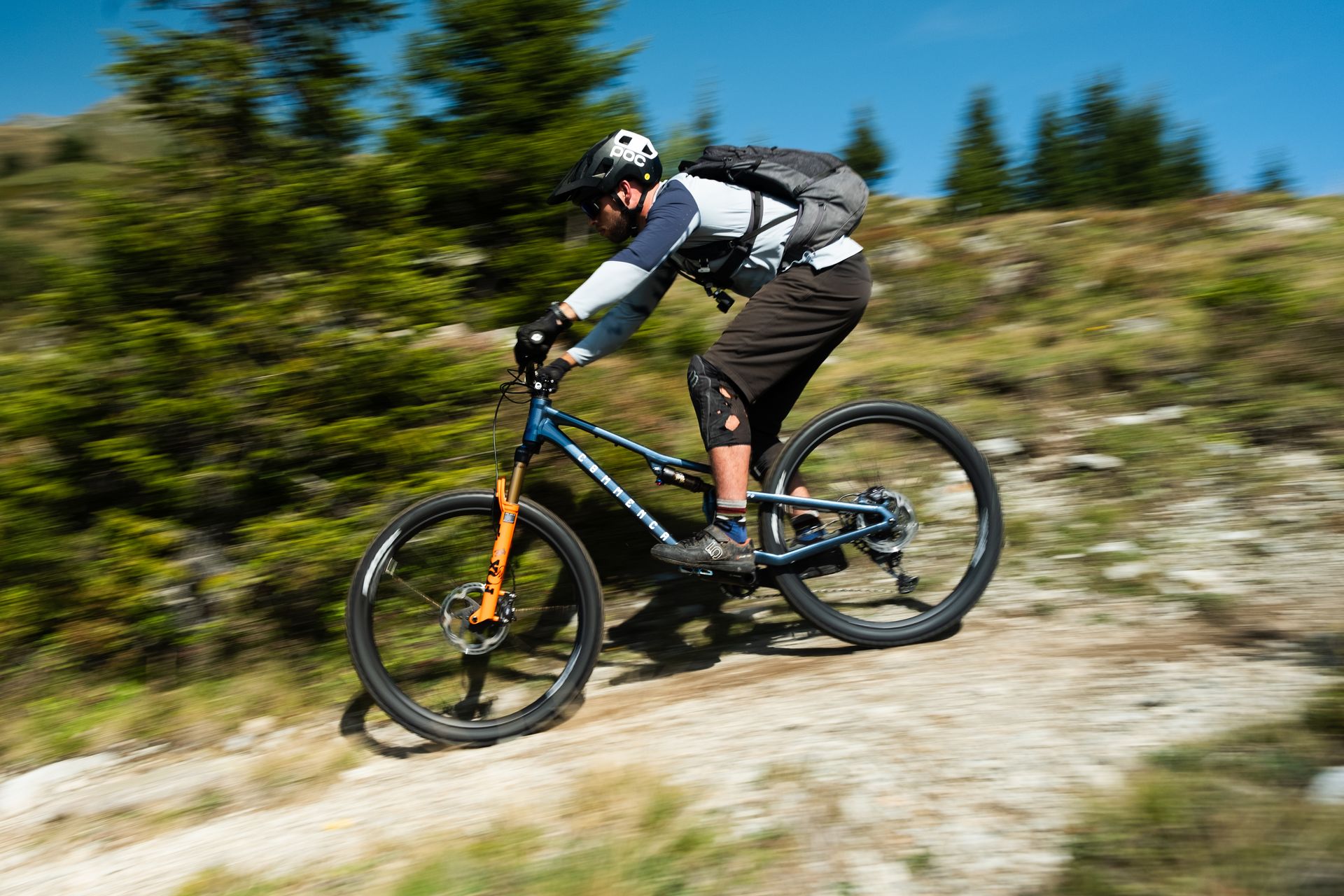 Rider catching air on a rocky alpine descent